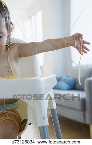 Picture - Girl (2-3) eating spaghetti. Fotosearch