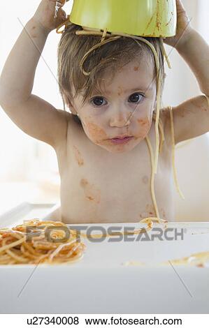 Stock Photo - Girl (2-3) eating spaghetti. Fotosearch