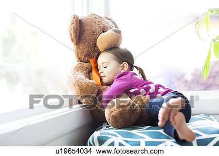 Girl (4-5) embracing teddy bear View Large Photo Image Picture - Girl (4-5) embracing teddy bear. Fotosearch