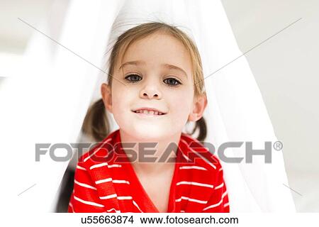 Picture - Girl (4-5) hiding in bed. Fotosearch