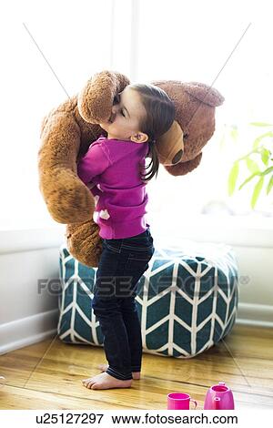 Girl (4-5) hugging teddy bear View Large Photo Image Stock Photo - Girl (4-5) hugging teddy bear. Fotosearch