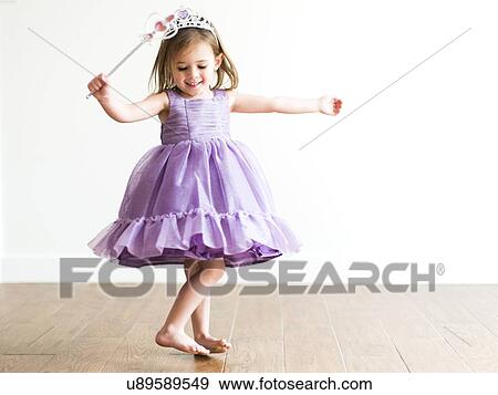 Girl (4-5) in princess costume dancing View Large Photo Image Stock Photo - Girl (4-5) in princess costume dancing. Fotosearch