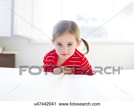 Girl (4-5) leaning on bed View Large Photo Image Stock Image - Girl (4-5) leaning on bed. Fotosearch