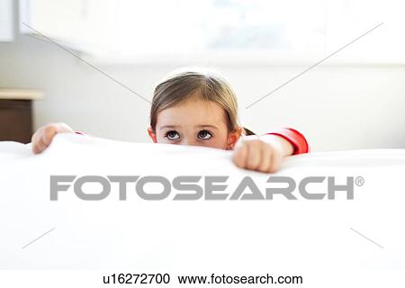 Girl (4-5) peeking over bed edge View Large Photo Image Stock Image - Girl (4-5) peeking over bed edge. Fotosearch