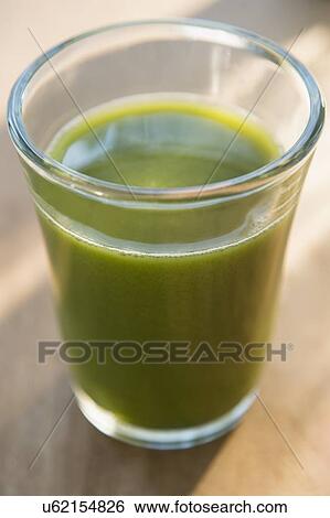 Glass of green juice View Large Photo Image Stock Photograph - Glass of green juice. Fotosearch