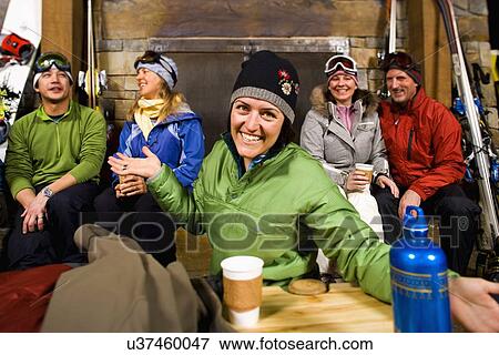 Group of skiers hanging out at fireplace View Large Photo Image Stock Photo - Group of skiers hanging out at fireplace. Fotosearch