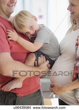 Picture - Happy boy (2-3) spending time with his parents in living room. Fotosearch