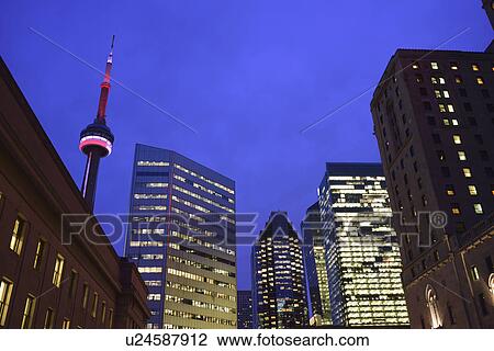 Stock Image - Illuminated city at dusk and CN Tower. Fotosearch