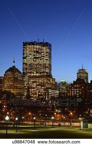 Stock Photo - Illuminated office buildings at dusk. Fotosearch