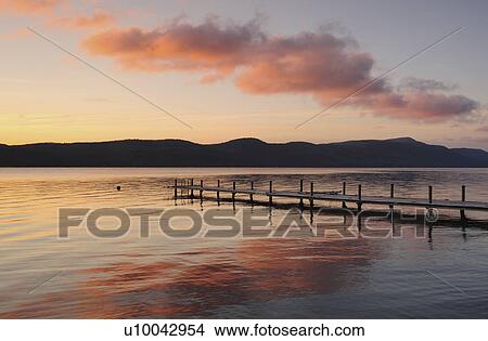 Jetty on lake at dawn View Large Photo Image Picture - Jetty on lake at dawn. Fotosearch