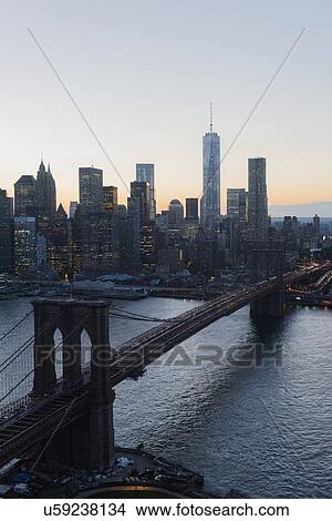 "Lower Manhattan, View of Brooklyn Bridge and One World Trade Center at dusk" View Large Photo Image Picture - "Lower Manhattan, View of Brooklyn Bridge and One World Trade Center at dusk". Fotosearch
