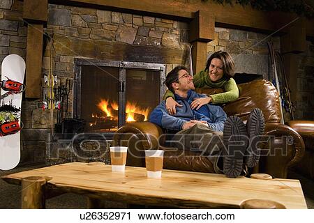 Man and woman hanging out in front of fireplace View Large Photo Image Stock Image - Man and woman hanging out in front of fireplace. Fotosearch