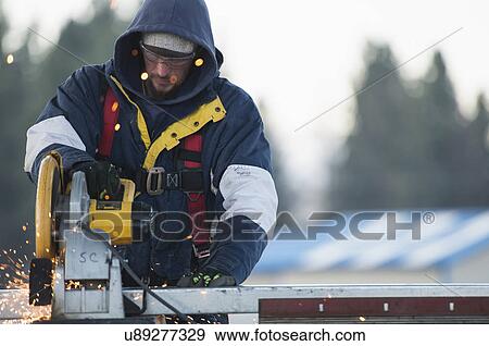Man cutting steel bar View Large Photo Image Stock Photo - Man cutting steel bar. Fotosearch