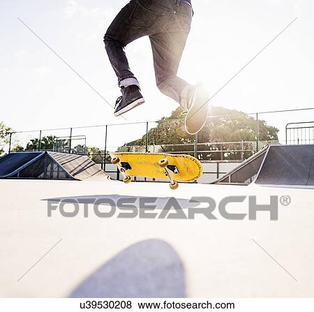Man skateboarding in skatepark View Large Photo Image Stock Photo - Man skateboarding in skatepark. Fotosearch