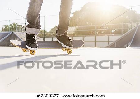 Man skateboarding in skatepark View Large Photo Image Stock Photo - Man skateboarding in skatepark. Fotosearch