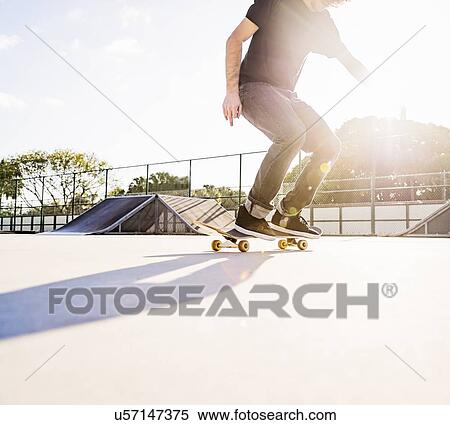 Man skateboarding in skatepark View Large Photo Image Stock Photography - Man skateboarding in skatepark. Fotosearch