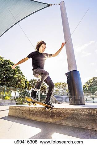 Man skating in skatepark View Large Photo Image Stock Photo - Man skating in skatepark. Fotosearch