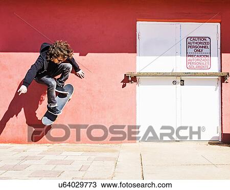 Man skating near red wall View Large Photo Image Stock Image - Man skating near red wall. Fotosearch