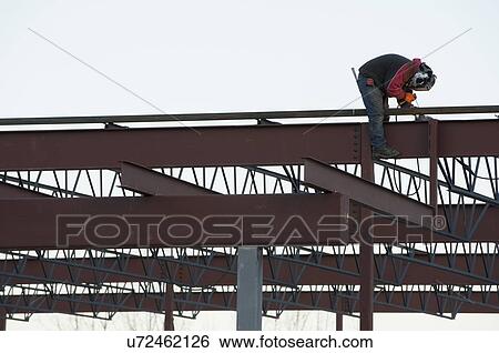 Stock Photograph - Man welding steel bar. Fotosearch