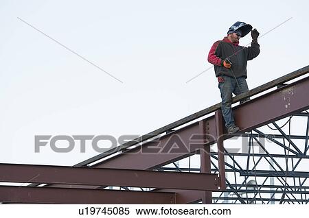 Stock Photography - Man welding steel bar. Fotosearch