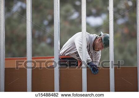 Stock Image - Man working at construction site. Fotosearch