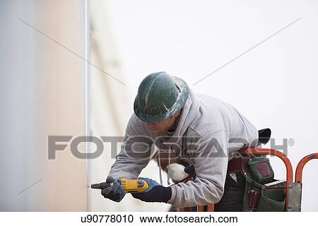 Man working at construction site View Large Photo Image Stock Image - Man working at construction site. Fotosearch