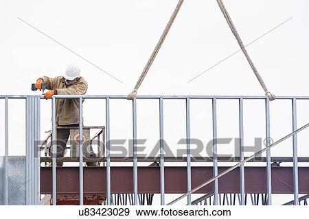 Man working at construction site View Large Photo Image Stock Photo - Man working at construction site. Fotosearch
