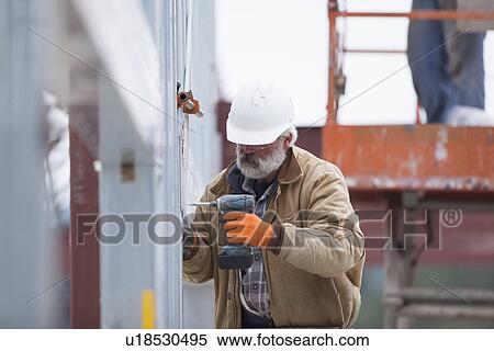 Man working at construction site View Large Photo Image Stock Photography - Man working at construction site. Fotosearch
