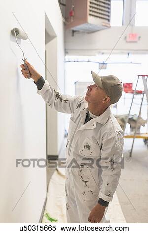 Manual worker painting wall View Large Photo Image Stock Photography - Manual worker painting wall. Fotosearch