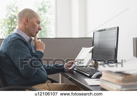 Mature businessman working in office View Large Photo Image Stock Photo - Mature businessman working in office. Fotosearch