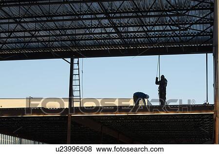 Stock Photo - Men working at construction site. Fotosearch