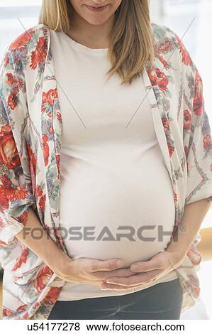 Stock Photo - Mid-section of pregnant woman . Fotosearch
