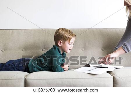 Stock Image - Mom giving advice to her son (2-3). Fotosearch