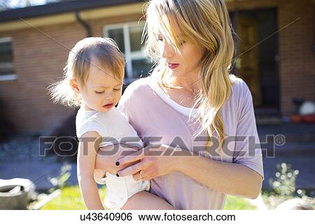 Mother and daughter (12-17 months) in backyard View Large Photo Image Stock Photograph - Mother and daughter (12-17 months) in backyard. Fotosearch