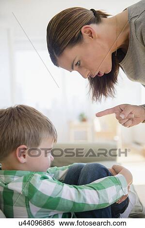 Stock Photography - Mother giving lecture to son (6-7) . Fotosearch