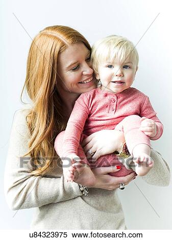 Stock Photography - Mother holding baby son (2-3). Fotosearch