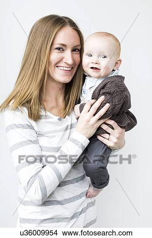 Picture - Mother holding baby son (6-11 months). Fotosearch