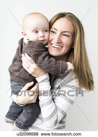 Mother holding baby son (6-11 months) View Large Photo Image Stock Photo - Mother holding baby son (6-11 months). Fotosearch
