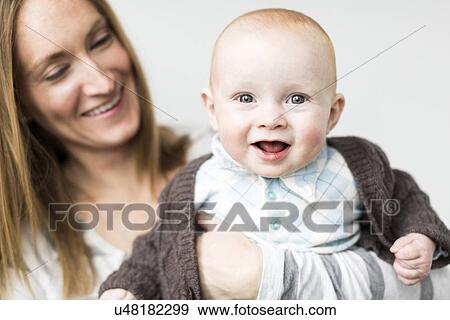 Mother holding baby son (6-11 months) View Large Photo Image Stock Photo - Mother holding baby son (6-11 months). Fotosearch
