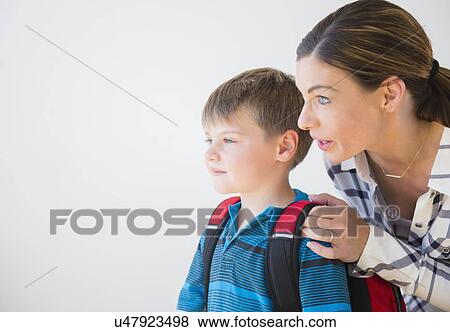 Mother preparing son (6-7) for school View Large Photo Image Stock Photo - Mother preparing son (6-7) for school. Fotosearch