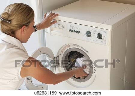 "Netherlands, Goirle, Woman doing laundry" View Large Photo Image Stock Photo - "Netherlands, Goirle, Woman doing laundry". Fotosearch