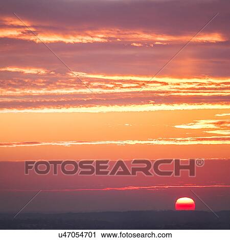 Stock Image - Orange sky at sunset. Fotosearch