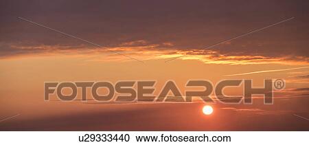 Stock Image - Panoramic view of sky at sunset. Fotosearch