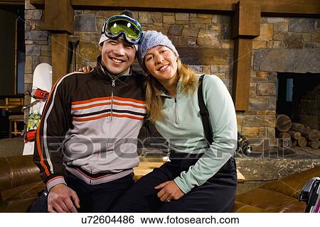 Stock Photograph - Portrait of couple in front of fireplace. Fotosearch