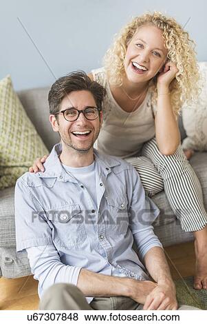 Stock Photo - Portrait of couple in living room. Fotosearch
