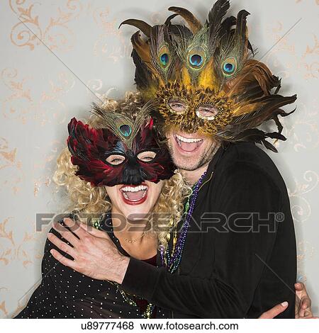 Stock Photo - Portrait of couple wearing holiday costumes. Fotosearch
