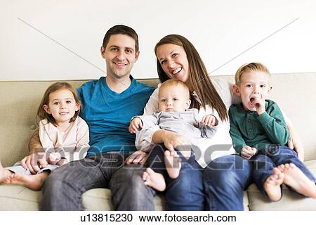 "Portrait of family with three children (2-3, 4-5) sitting on sofa" View Large Photo Image Stock Image - "Portrait of family with three children (2-3, 4-5) sitting on sofa". Fotosearch