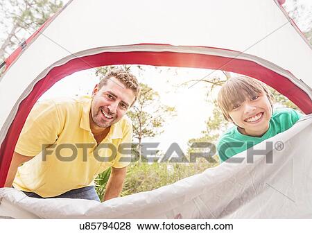 Portrait of father and son (12-13) looking into tent View Large Photo Image Stock Photo - Portrait of father and son (12-13) looking into tent. Fotosearch