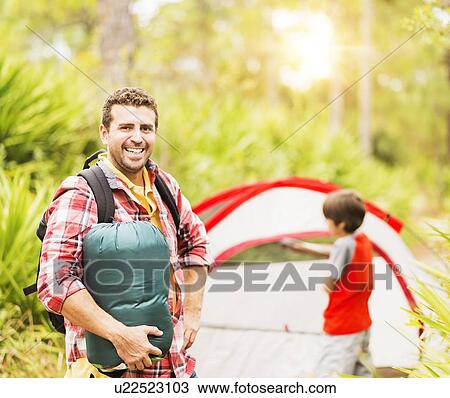 Portrait of man in forest with his son (12-13) in background View Large Photo Image Stock Image - Portrait of man in forest with his son (12-13) in background. Fotosearch