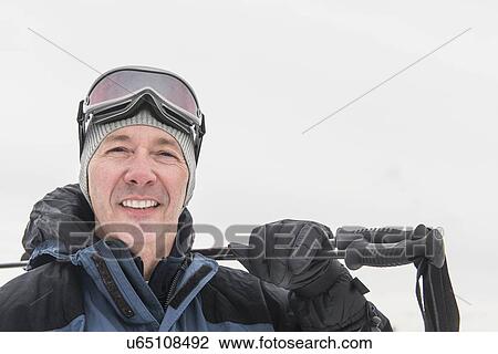 Stock Image - Portrait of mature male skier. Fotosearch